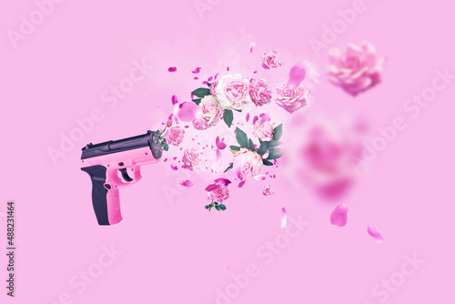 Pink gun shoots flowers, creative idea and marketing. No war, do love and beauty. Pink flowers roses and peonies with petals flying on a pink background