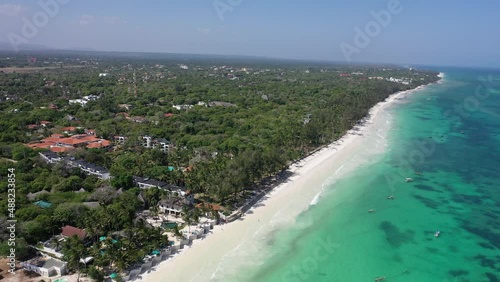 Diani beach Kenyan coast African Sea drone aerial 4k waves blue indan ocean tropical mombasa turquoise white sand East Africa palms paradise view Kenya landscape