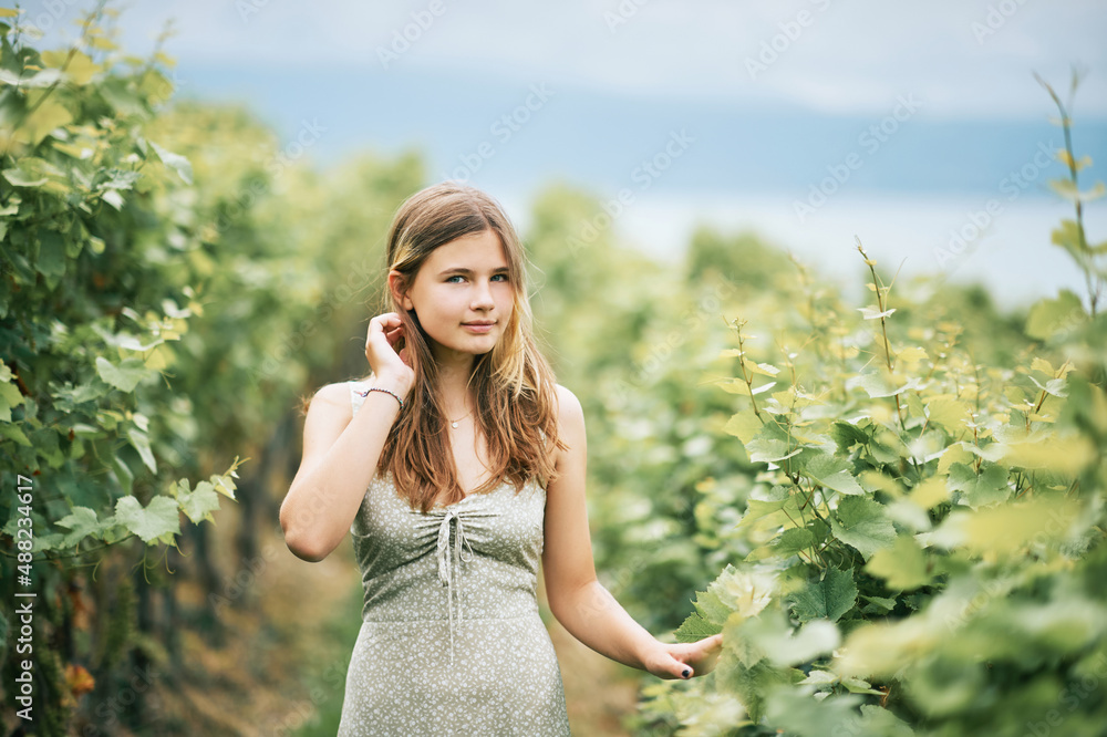 Outdoor portrait of pretty young teenager girl hiking in vineyards, summer activities