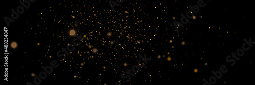 Glowing light effect in yellow gold color with lots of shiny particles isolated on dark background. Vector star cloud with dust.	

