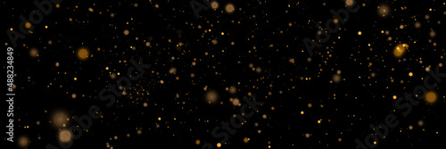 Glowing light effect in yellow gold color with lots of shiny particles isolated on dark background. Vector star cloud with dust. © MAKSYM