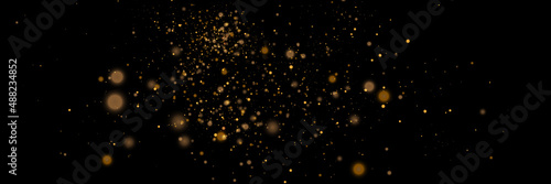 Glowing light effect in yellow gold color with lots of shiny particles isolated on dark background. Vector star cloud with dust. 