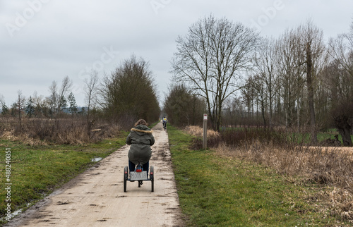Hakendover, Flanders - Belgium - 03 02 2019: Young white woman with Down Syndrome drive a tricycle