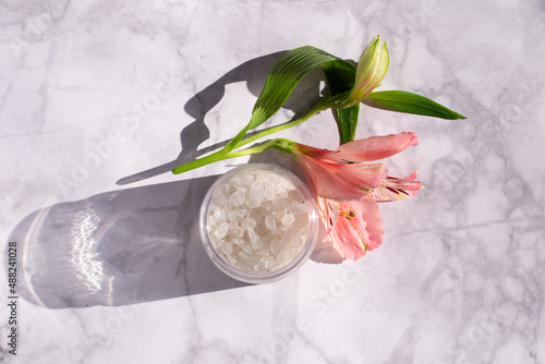 Wallpaper Mural White bath salt with flowers on a  marble background. Perfumed salt in a bottle.  Torontodigital.ca