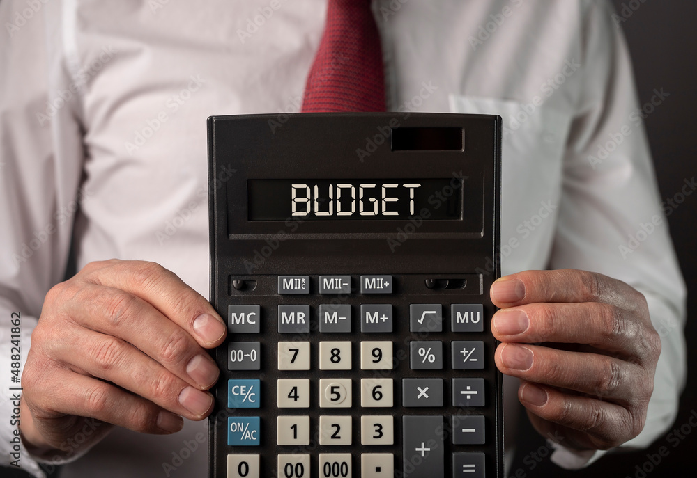 Budget word on calculator with dollars money. Photo Budget word on calculator with dollars money. Photo