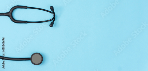 Stethoscope on blue background. Medical background. Doctor equipment. Health care concept. Copy space, top view