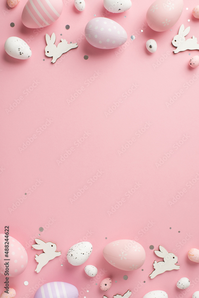 Top view vertical photo of easter decorations shiny confetti easter bunnies  lilac pink and white easter eggs on isolated pastel pink background with  empty space Stock Photo | Adobe Stock