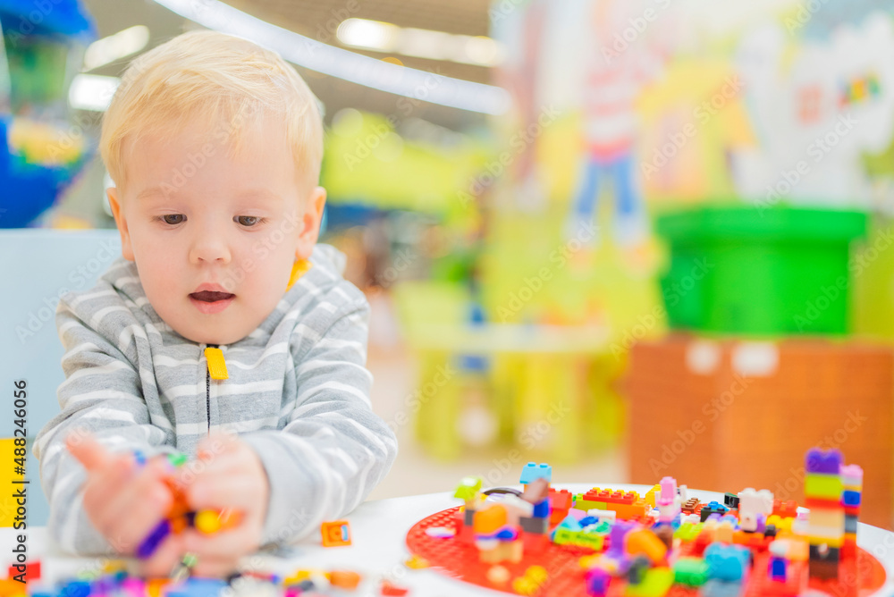 little boy play colorful cubes puzzle at the table little boy play colorful cubes puzzle at the table