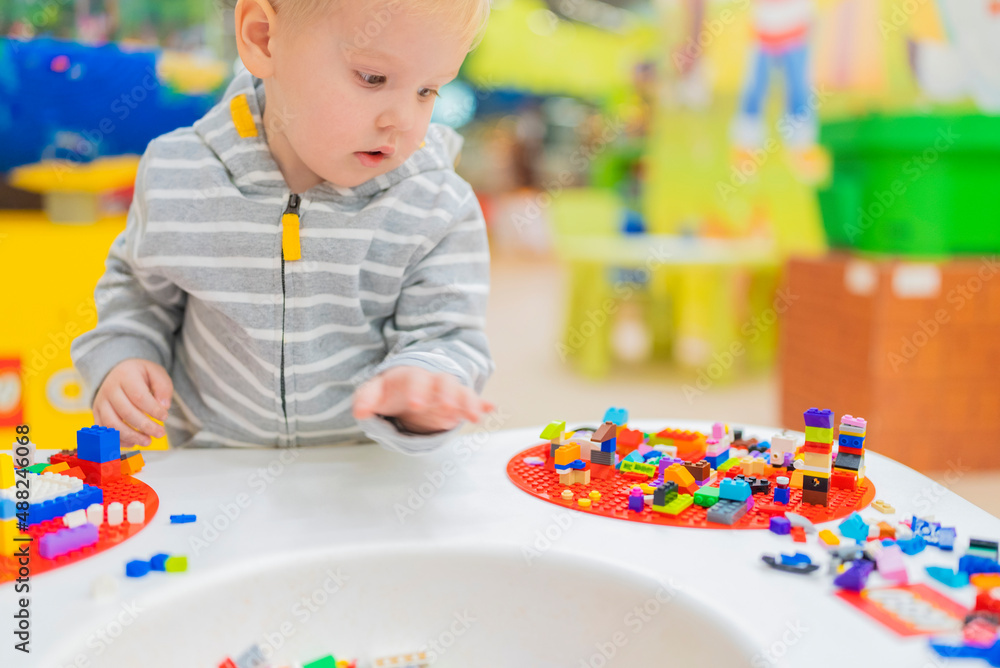 little boy play colorful cubes puzzle at the table little boy play colorful cubes puzzle at the table