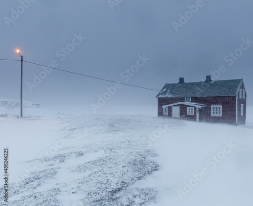  small wooden hut in the snow storm