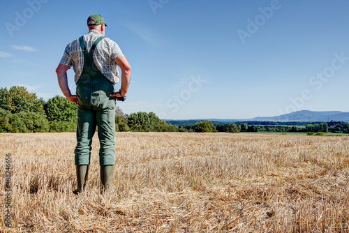 After the harvest, a farmer stands on his mown grain field and enjoys the view over the vast country to the foothills of the Swabian Alb. © BIB-Bilder