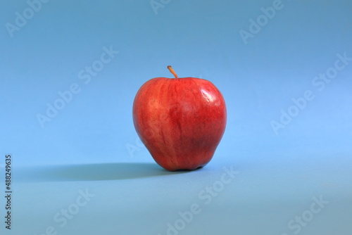 A red apple on a blue background