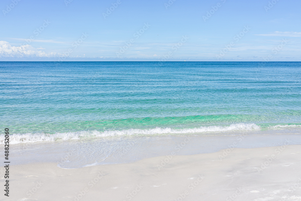 Barefoot beach in Southwest Naples, Florida with idyllic blue clear transparent water on empty summer day gulf of mexico coast horizon in paradise landscape