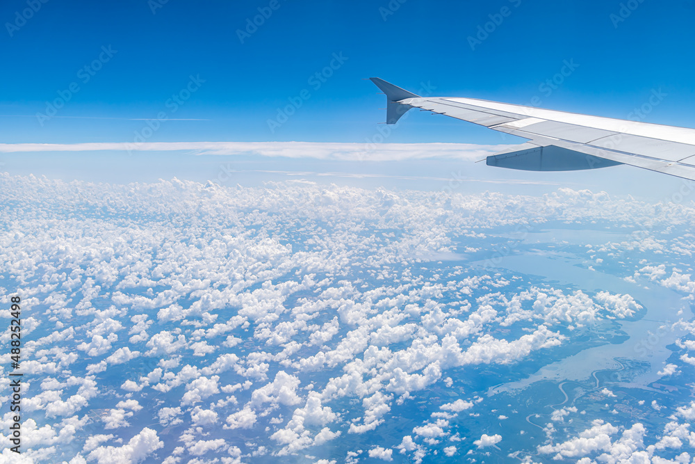 Window high angle aerial view of blue sky horizon above Virginia on sunny day cloudscape natural clouds pattern formation and Potomac River flowing into Chesapeake Bay Window high angle aerial view of blue sky horizon above Virginia on sunny day cloudscape natural clouds pattern formation and Potomac River flowing into Chesapeake Bay