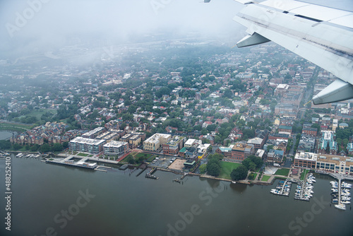 Airplane aerial view through window of Alexandria in Northern Virginia on a cloudy day near Washington DC Potomac river descending to Reagan National Airport photo