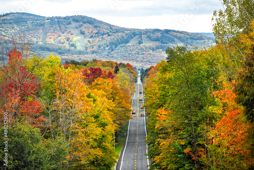West Virginia road highway with many cars traffic in colorful autumn fall near Blackwater Falls State park and Seneca Rocks with steep ski resort slope hill photo