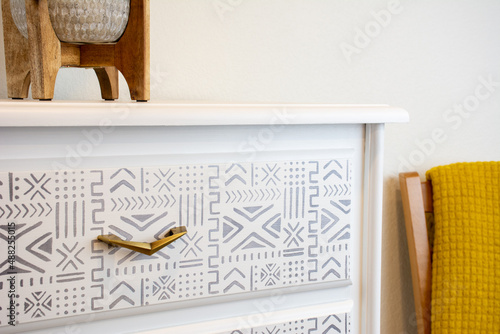 Boho Chalk Painted dresser with stenciled design and mid-century modern pulls. Bohemian chic furniture with drawers for the home interior.