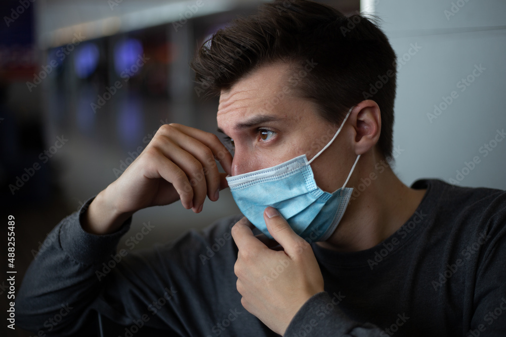 Man with a medical mask touching mask