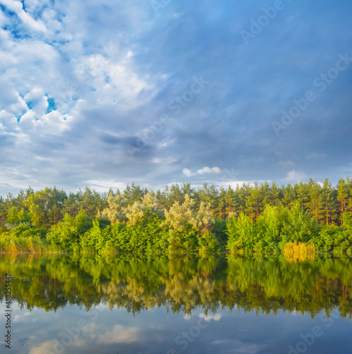 quiet summer river under dense cloudy sky