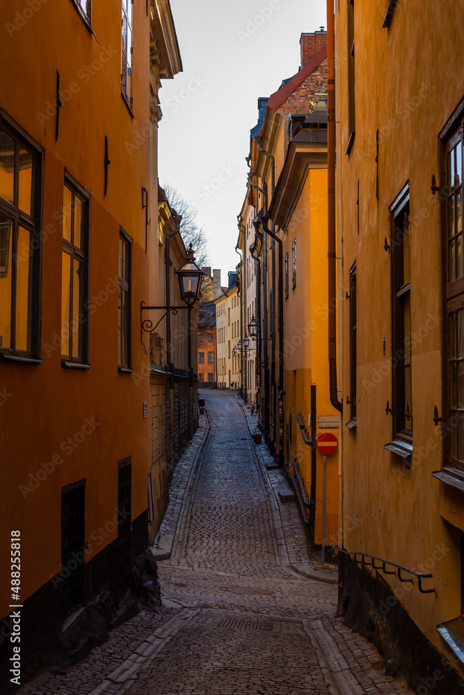 Narrow street in Europe in Stockholm without people during the day with a paved road