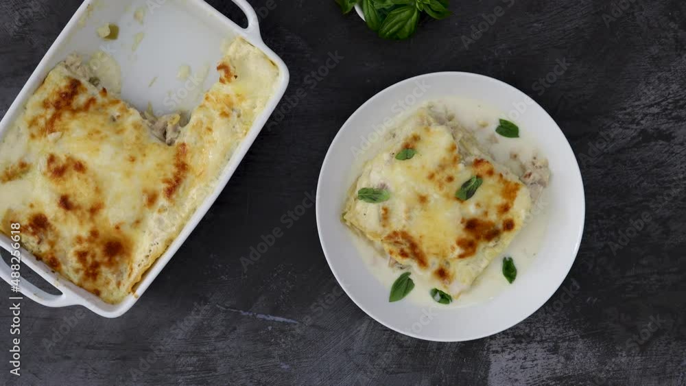 Serving Chicken Lasagna with Basil and Creamy White Sauce Serving Chicken Lasagna with Basil and Creamy White Sauce