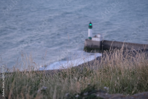 Green lighthouse by the sea