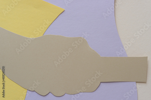 paper background with figural element in beige on yellow, mauve, and ivory photo