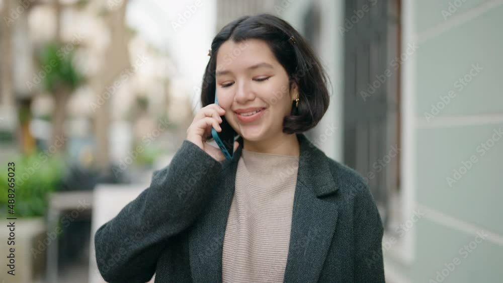 Young hispanic girl smiling confident talking on the smartphone at street Young hispanic girl smiling confident talking on the smartphone at street