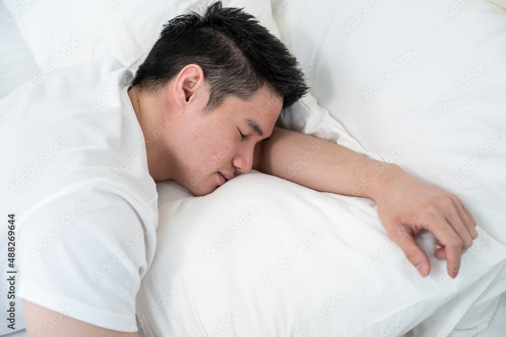 Asian attractive comfort male in pajamas get up from sleep in bedroom. Asian attractive comfort male in pajamas get up from sleep in bedroom.