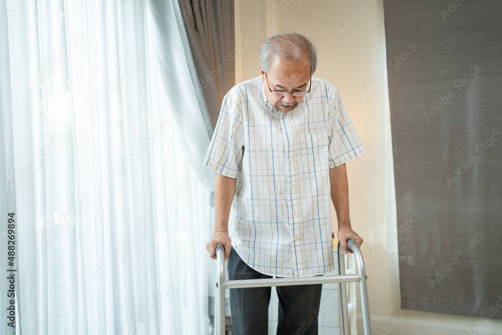 Asian Senior elderly man patient walking slowly with walker in house. Asian Senior elderly man patient walking slowly with walker in house.