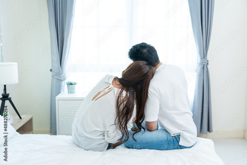 Asian new marriage couple sit on bed and hug at each other with love. Asian new marriage couple sit on bed and hug at each other with love.