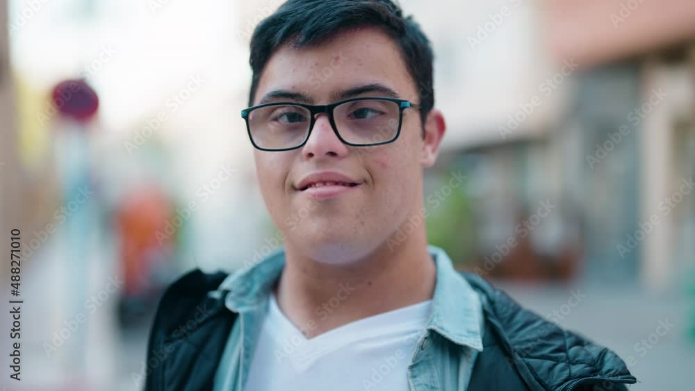 Down syndrome man smiling confident standing at street Down syndrome man smiling confident standing at street