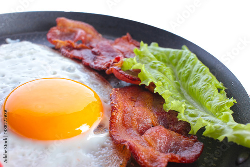 the fried egg, fried eggs, bacon meat, a lettuce leaf, food, a breakfast on a white background