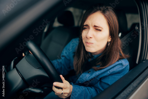 Woman Squinting and Driving Not Having Proper Visibility photo