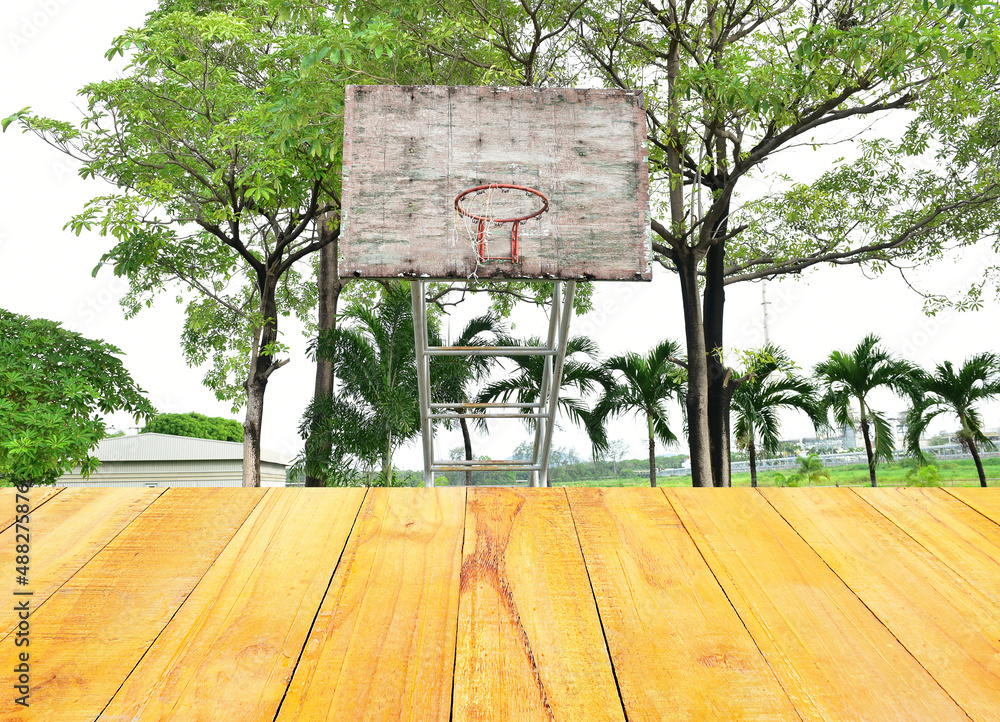 Basketball court with old wood backboard.blue sky and white clouds on