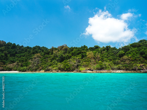 Ko Rang Island. Scenic rocky beach, clear turquoise seawater against summer blue sky. Mu Koh Chang National Park, Trat, Thailand.