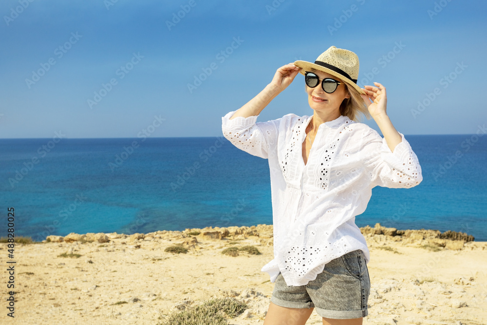 Happy mature woman on the beach during summer vacation. Summer vacation holiday concept. Happy mature woman on the beach during summer vacation. Summer vacation holiday concept.