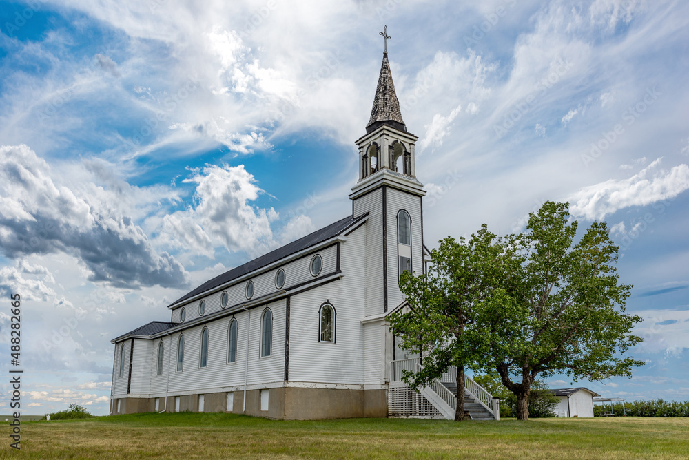 Fototapeta premium A dramatic sky over the Blumenfeld Roman Catholic Church near Leader, SK, Canada