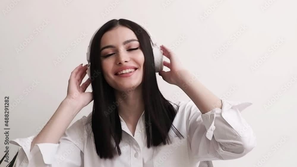 Beautiful young woman dancing and laughing in headphones Beautiful young woman dancing and laughing in headphones