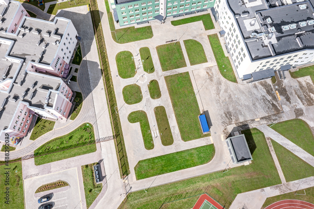 Obraz premium modern school complex in residential district. school courtyard with recreation area. aerial view.