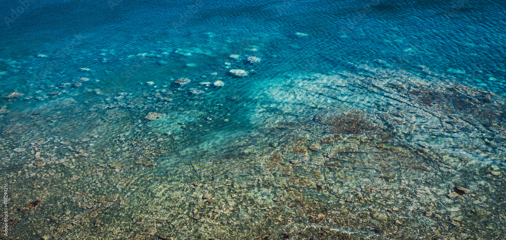 Fototapeta premium Sea surface with small waves, top view in blue and turquoise color tones