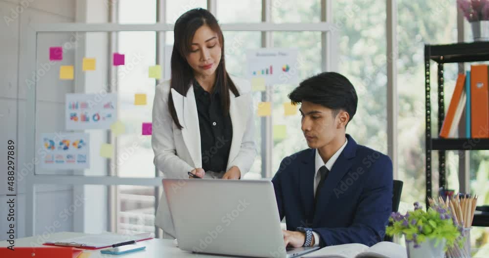 young businesspeople talking together using a Laptop together in a modern office young businesspeople talking together using a Laptop together in a modern office