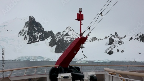 Cruise ship in Antarctica. Travel to the Antarctic peninsula. A beautiful polar nature with mountains, glaciers and icebergs. Snow covered mountains and Lemaire Channel. photo