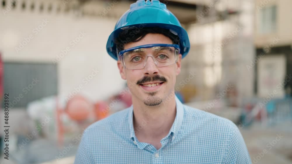 Young hispanic man architect smiling confident standing at street Young hispanic man architect smiling confident standing at street