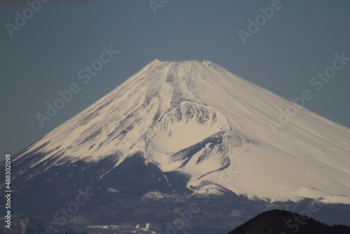 Isolated picture of the Mount Fuji in winter under a clear blue sky with snow-capped peak. Shot from Izu peninsula  Japan.