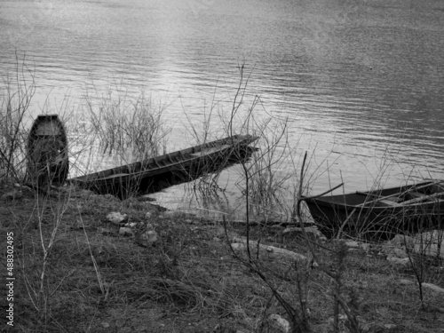 Two old wooden boats moored on the banks of the river. vintage tone