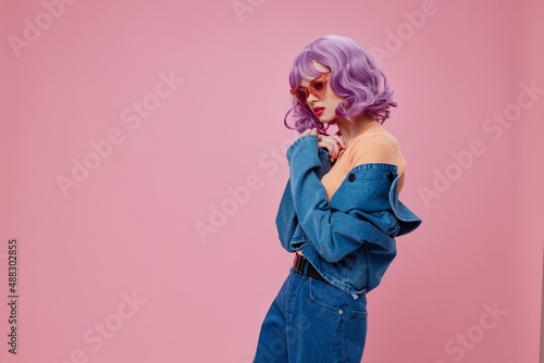 Positive young woman denim clothing fashion posing cap pink glasses color background unaltered