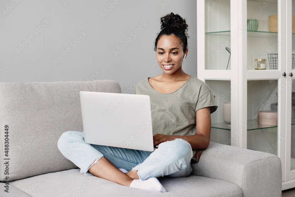 Young woman using laptop computer at home. Student girl working in her room. Work or study from home, freelance, business, lifestyle concept Young woman using laptop computer at home. Student girl working in her room. Work or study from home, freelance, business, lifestyle concept