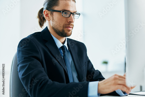 male manager at his desk working in front of a computer