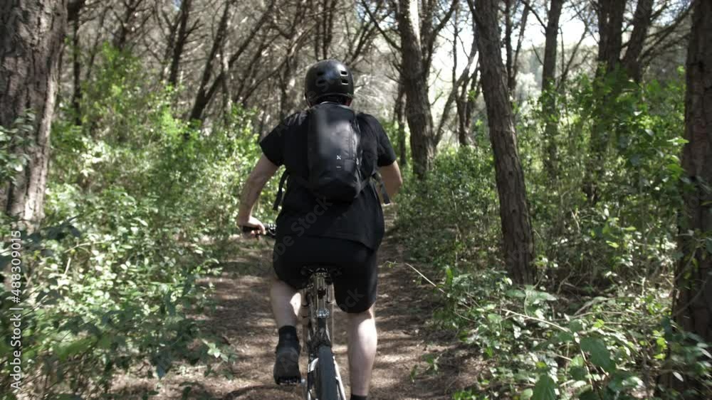 young man rides mountain bike in forest trail slow motion 4k young man rides mountain bike in forest trail slow motion 4k
